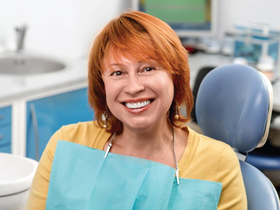 A smiling woman getting a dental exam