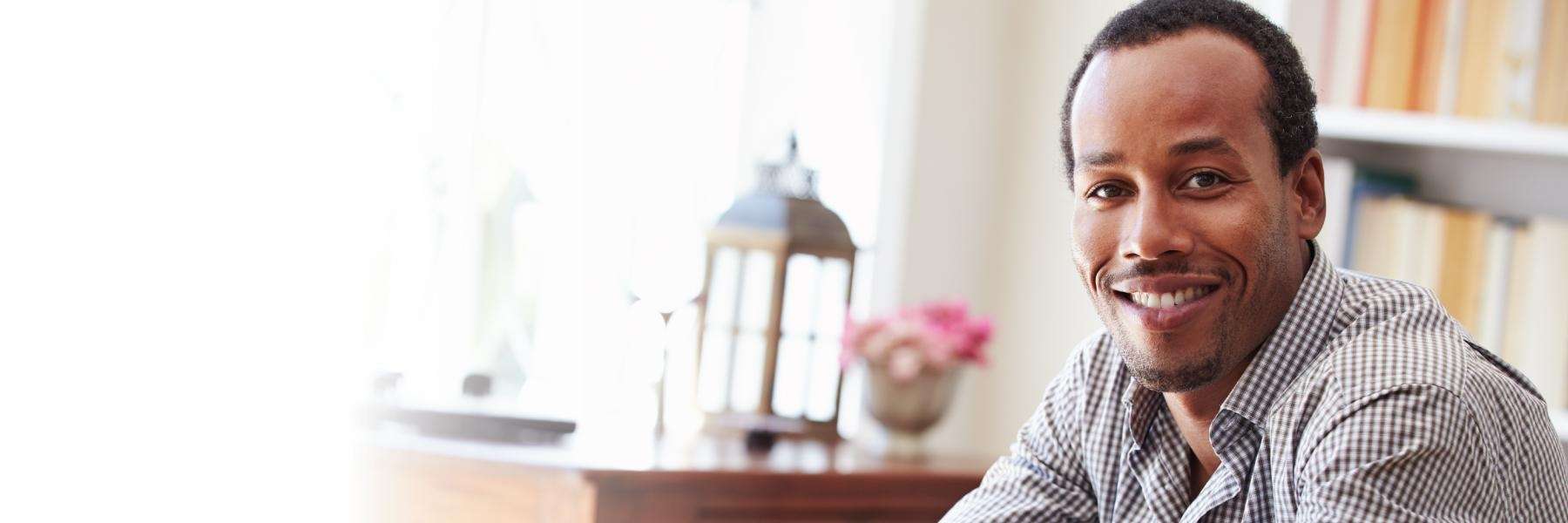 A smiling man in his home office