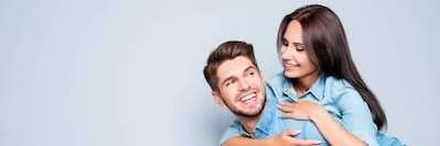 Woman riding on a man's back | Chesterfield Dentist