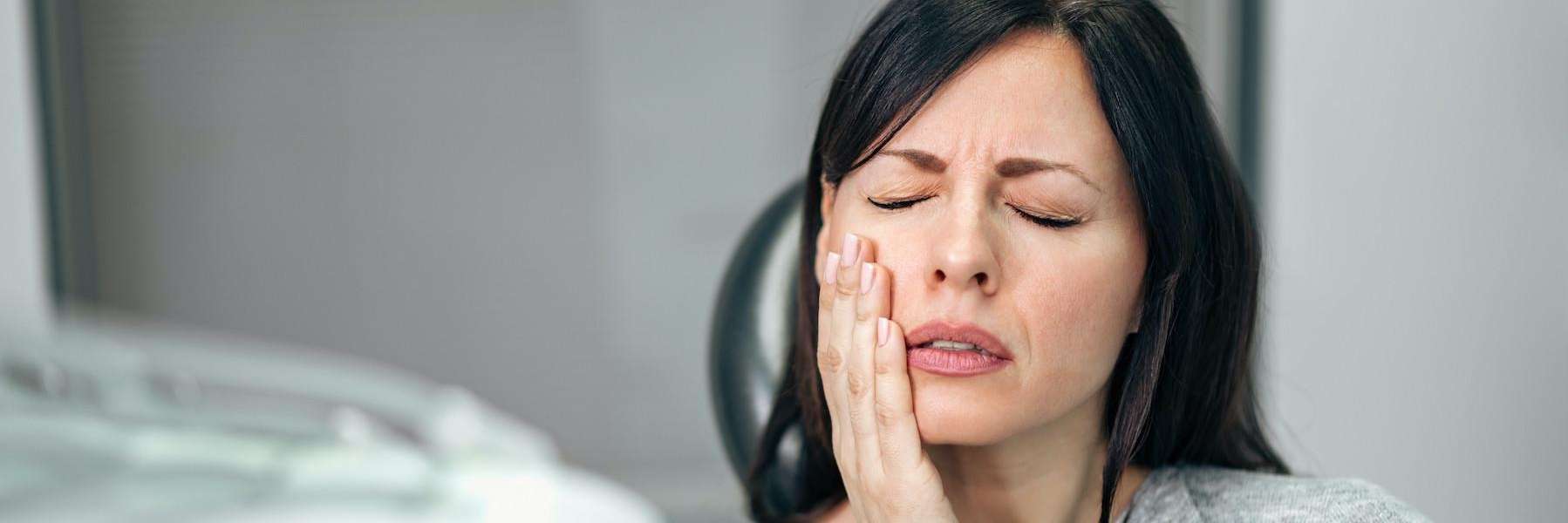A woman experiencing a dental emergency | dentist Chesterfield MO