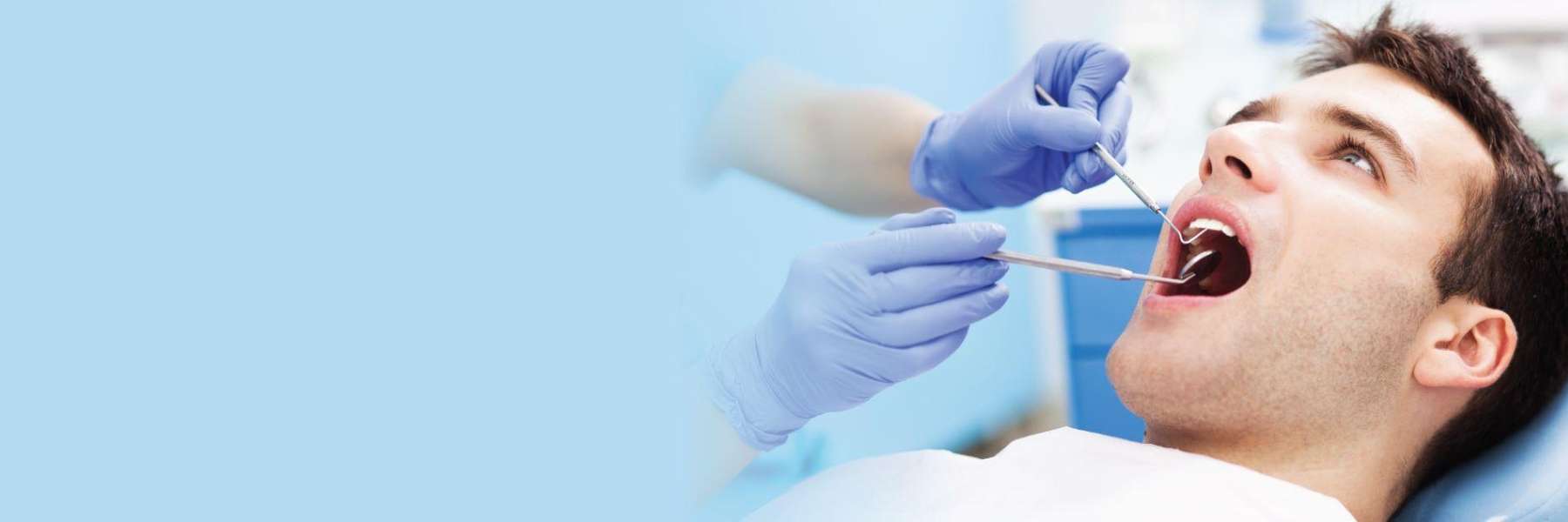 A man receiving a dental exam | emergency dentist