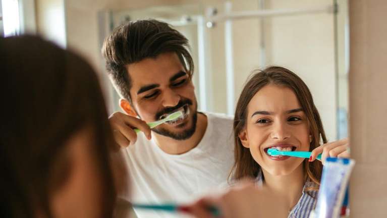 Two people brushing their teeth | General Dentist Chesterfield MO