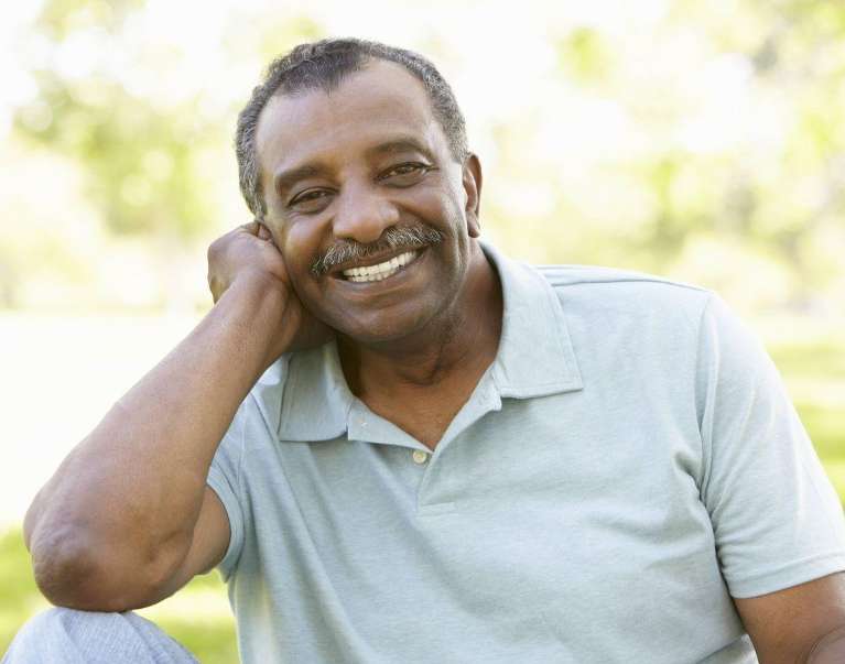 A smiling elderly man in the park