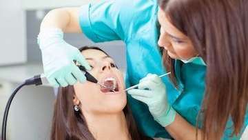 A woman getting her teeth cleaned