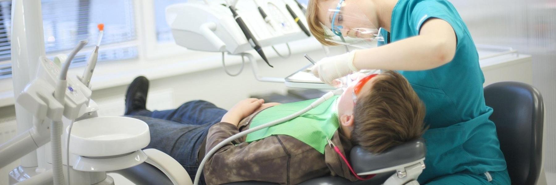 kid sitting in a dental chair