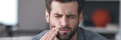 A man with jaw pain | dentist Chesterfield Missouri